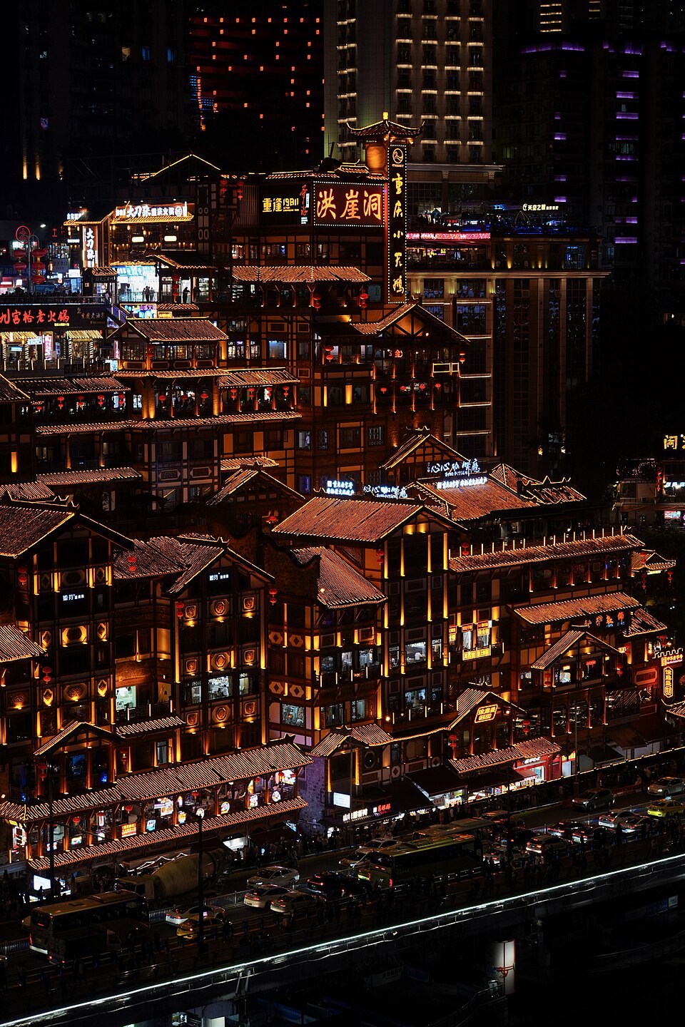 Hongyadong's illuminated terraces above the riverside street in Chongqing