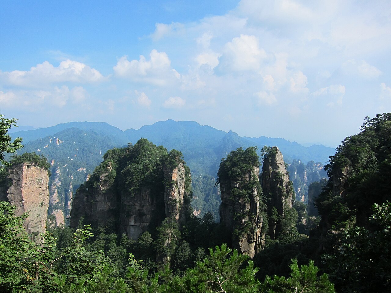 Tree-covered sandstone pillars rising above a Wulingyuan valley